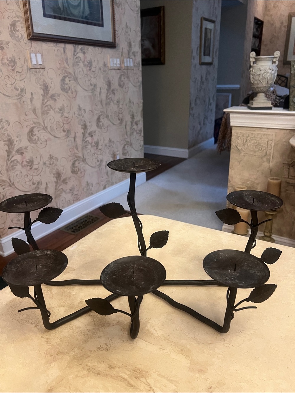 Wrought iron fireplace candelabra with an organic, botanical leaf-and-twig motif
